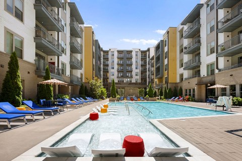 a rendering of an apartment building with a pool and christmas trees