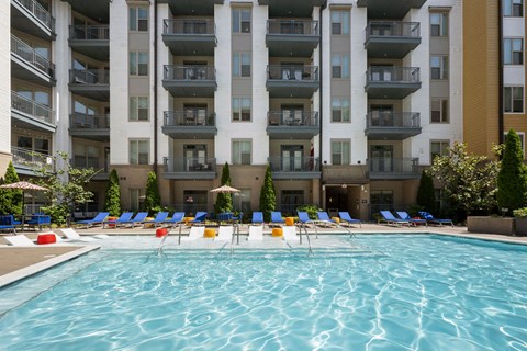a swimming pool in front of an apartment building