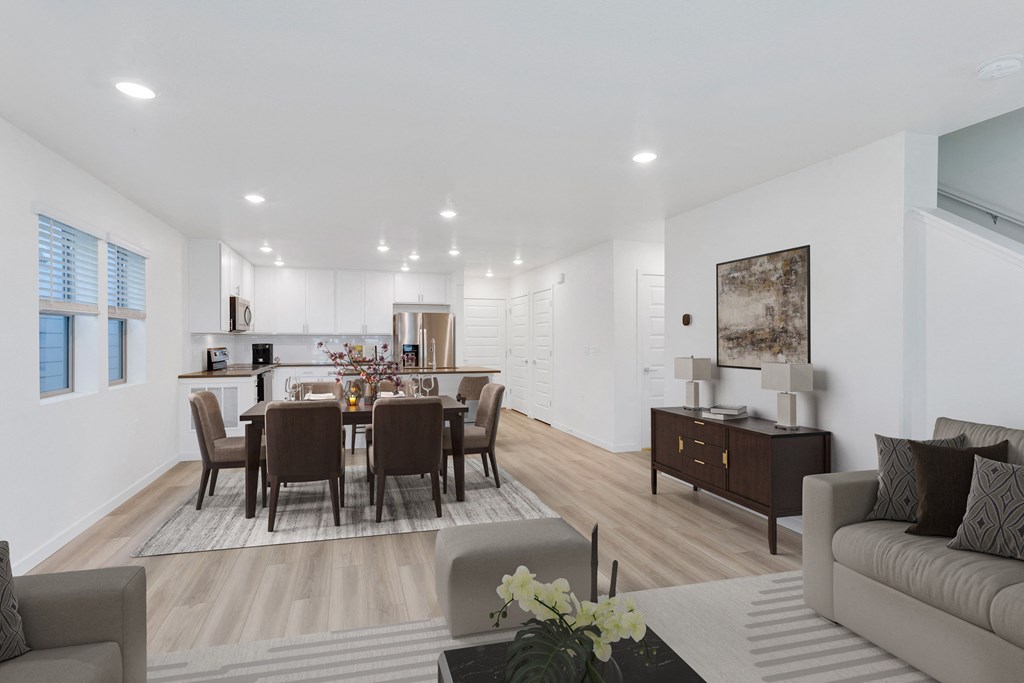 a living room and dining room with a table and chairs