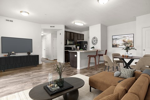 A living room with a brown couch and a black coffee table.