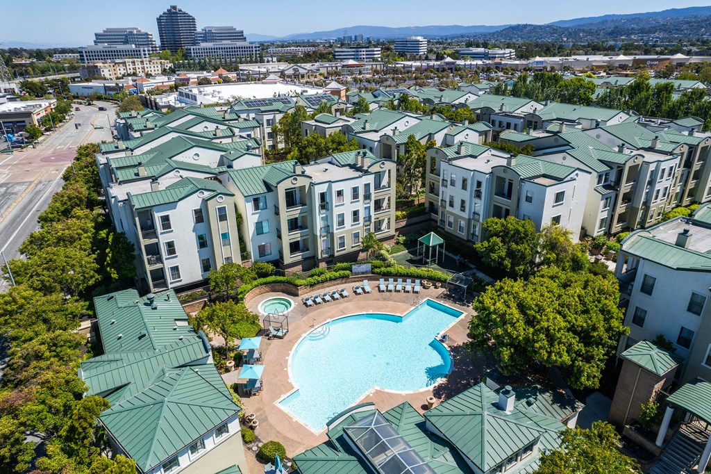 an aerial view of a swimming pool in the middle of an apartment complex