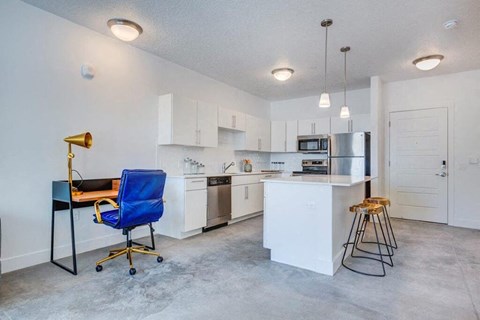 a kitchen with an island and a table and chairs