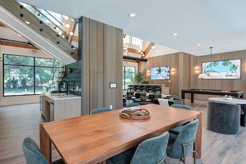 A modern dining room with a wooden table and chairs.