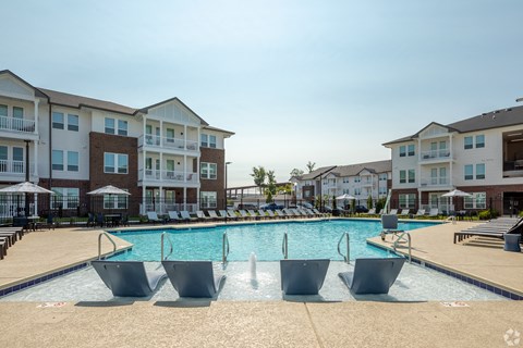 a swimming pool in front of an apartment building