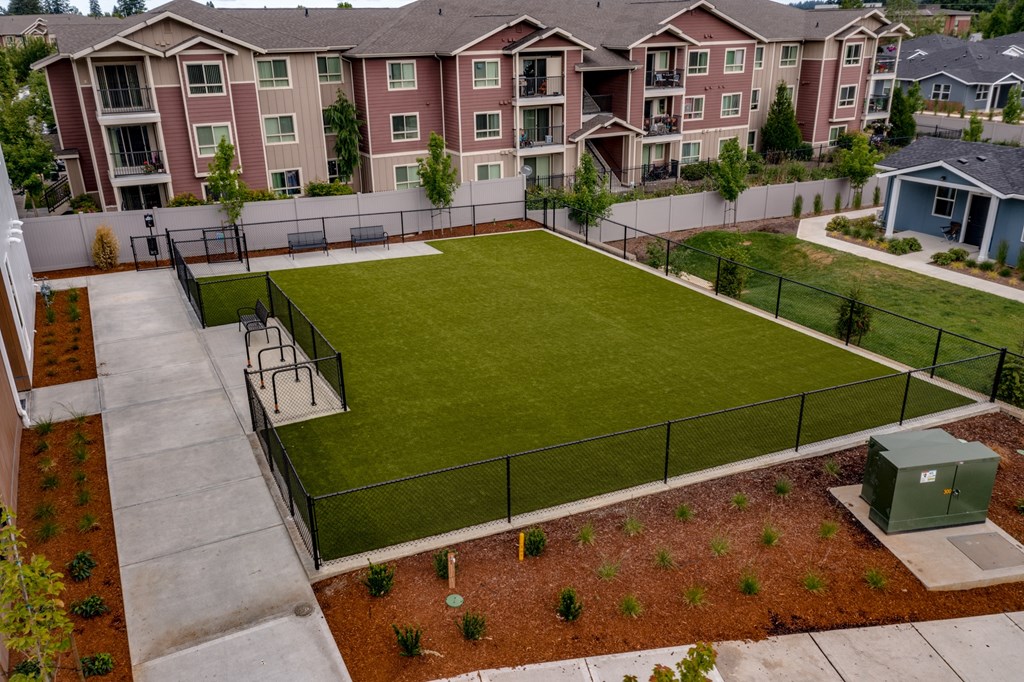 an aerial view of an apartment complex with a tennis court
