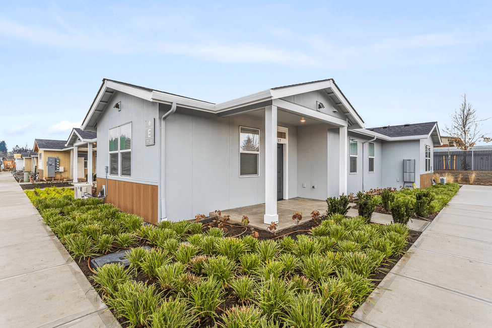 a home with a porch and a walkway with a garden