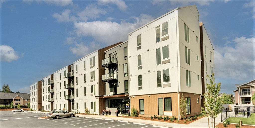 a new apartment building on the corner of a street
