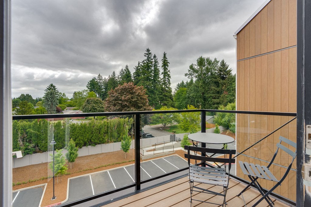 a patio with a table and chairs on a balcony