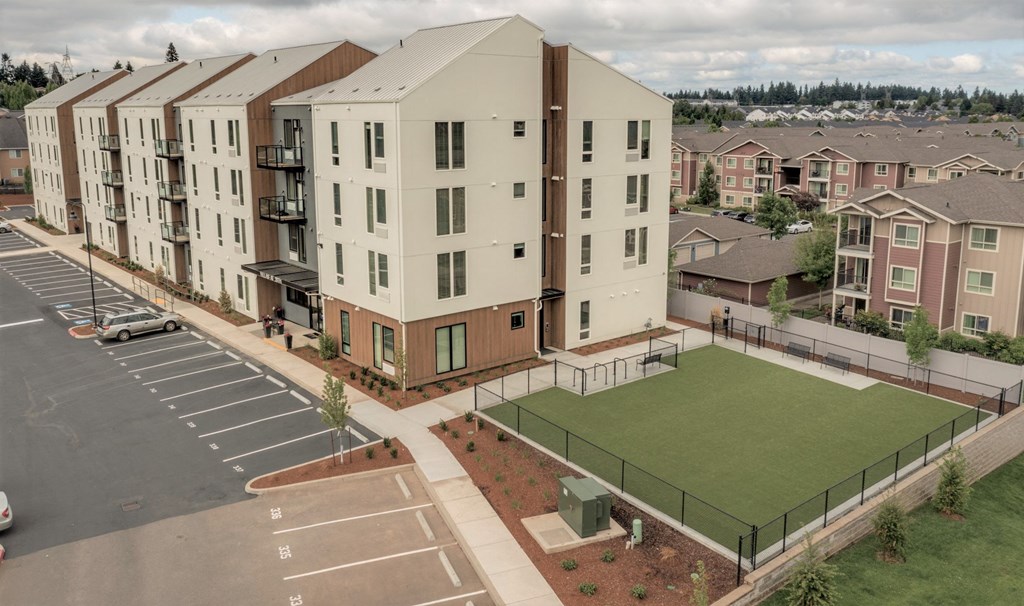 a rendering of a building with a tennis court in front of it
