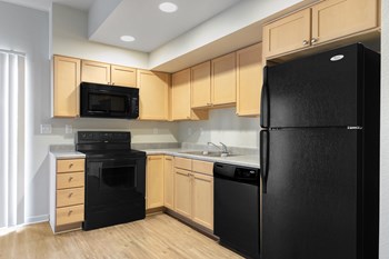 Wood style cabinetry with all black appliances - Photo Gallery 4