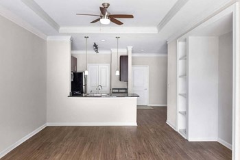 Living room featuring built-ins and view of the kitchen - Photo Gallery 5