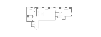 A floor plan of a building with multiple rooms and corridors.
