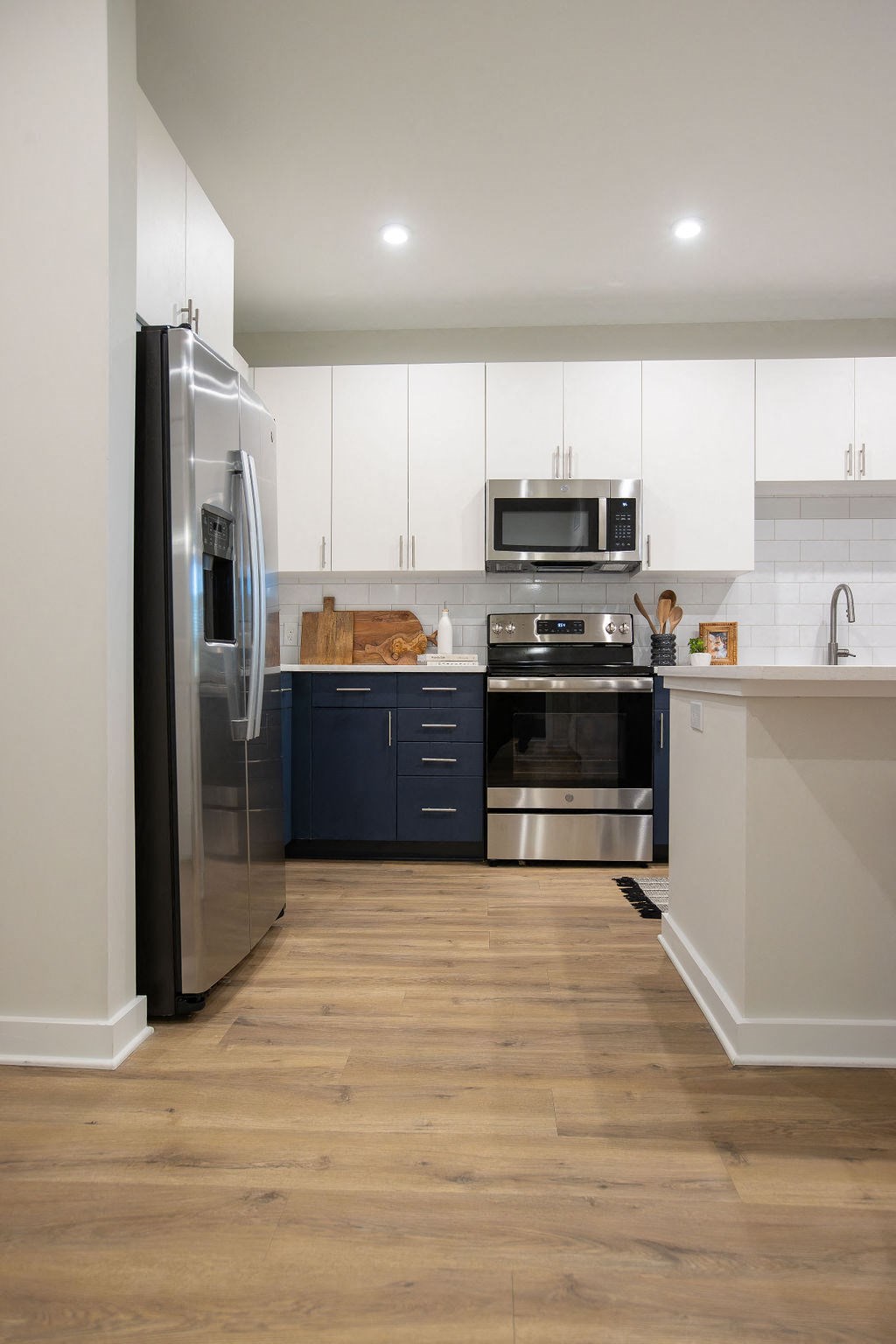 a kitchen with stainless steel appliances and white cabinets