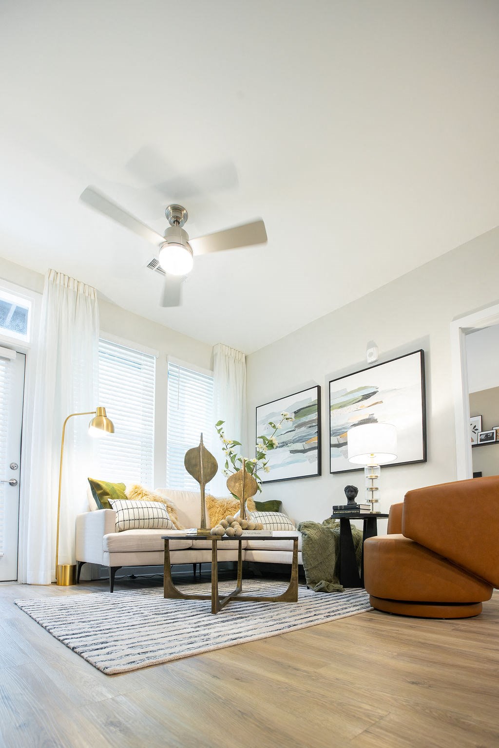 a living room with a couch and a ceiling fan
