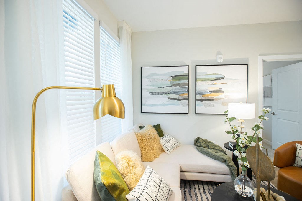 a living room with a couch and two pictures on the wall