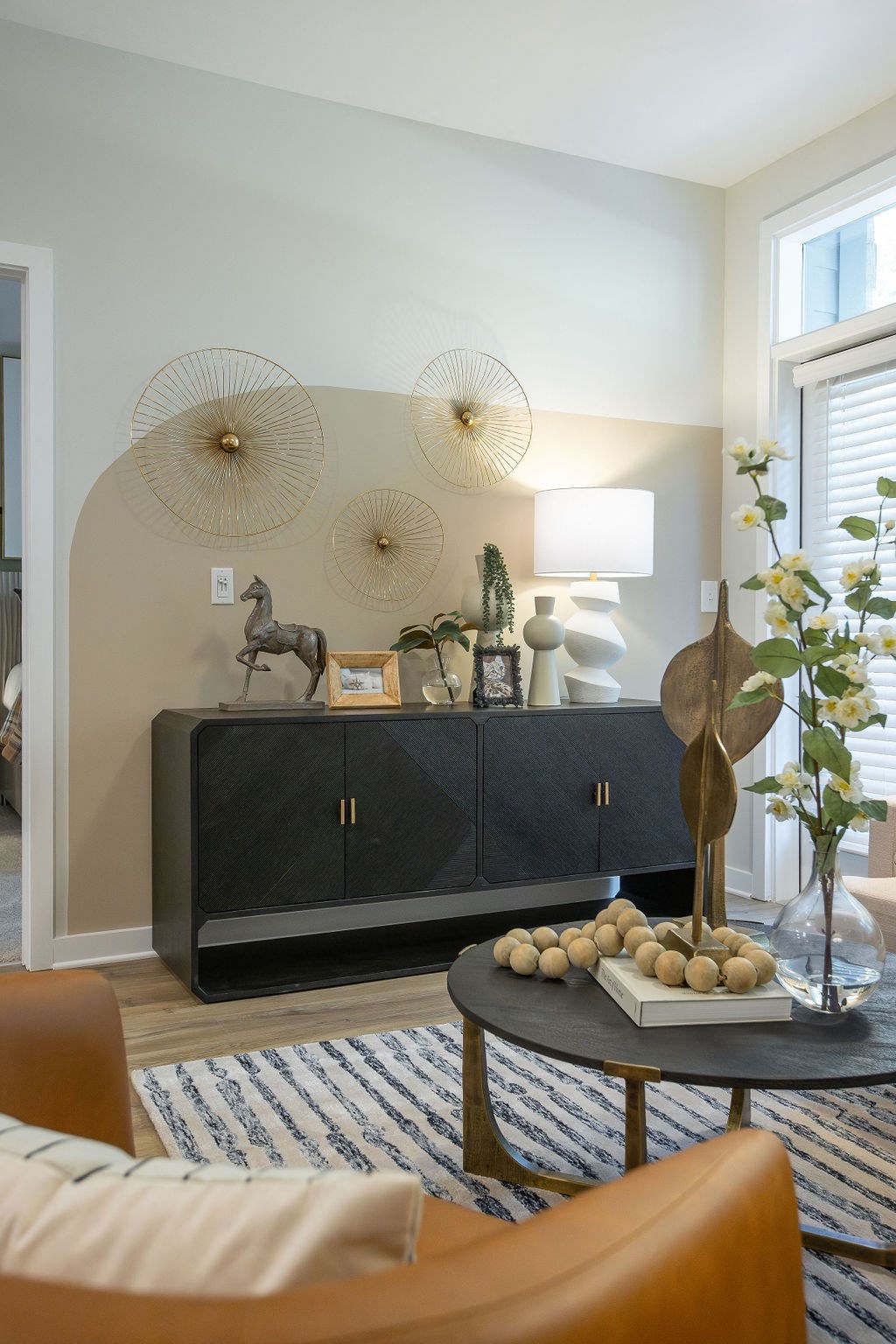a living room with a cabinet and a table with spheres on it