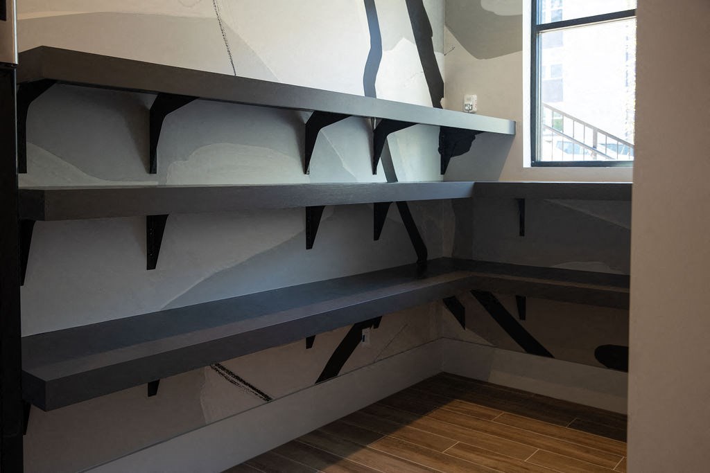 a large grey shelf in a room with a window