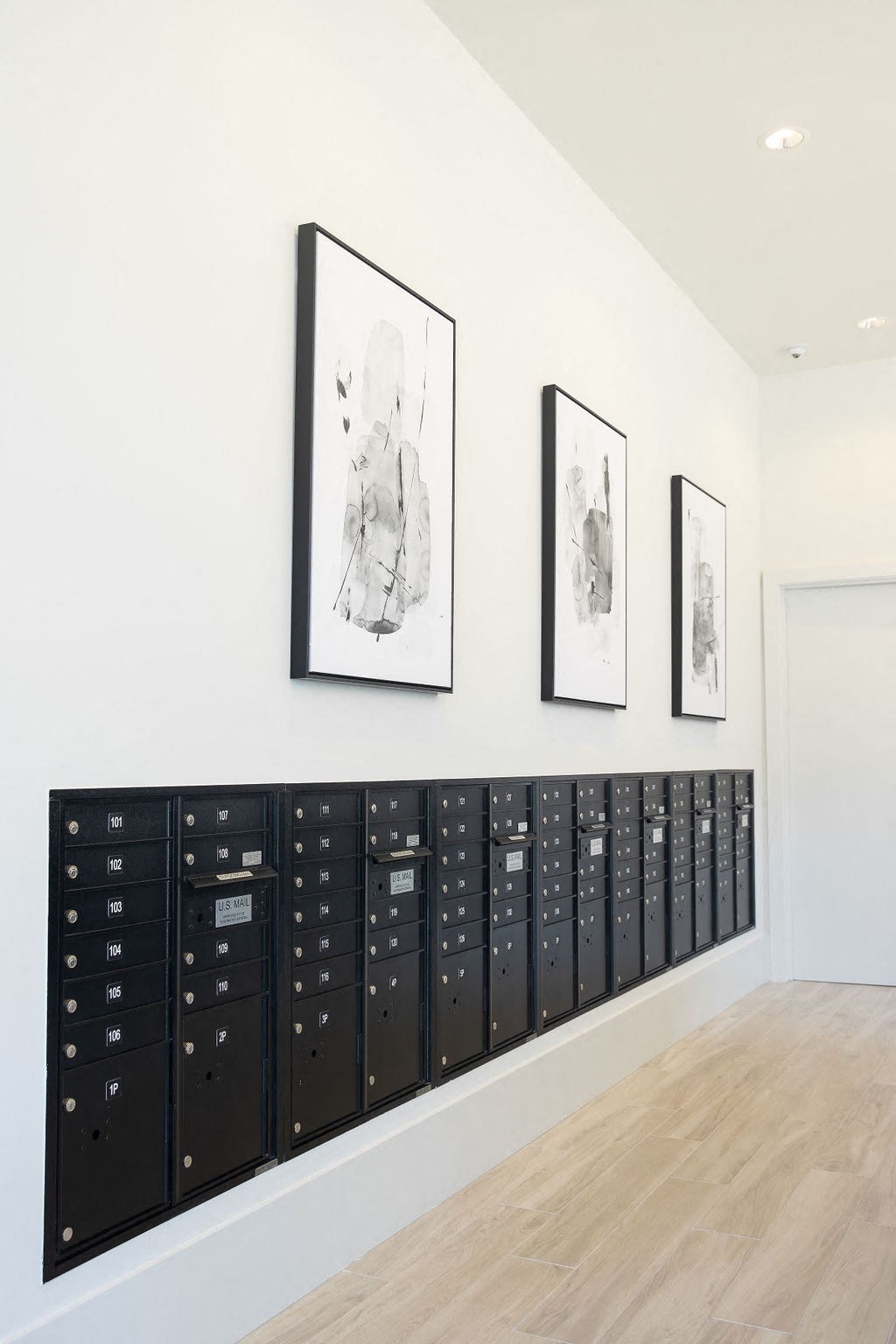 a lockers room with pictures on the wall and a wooden floor