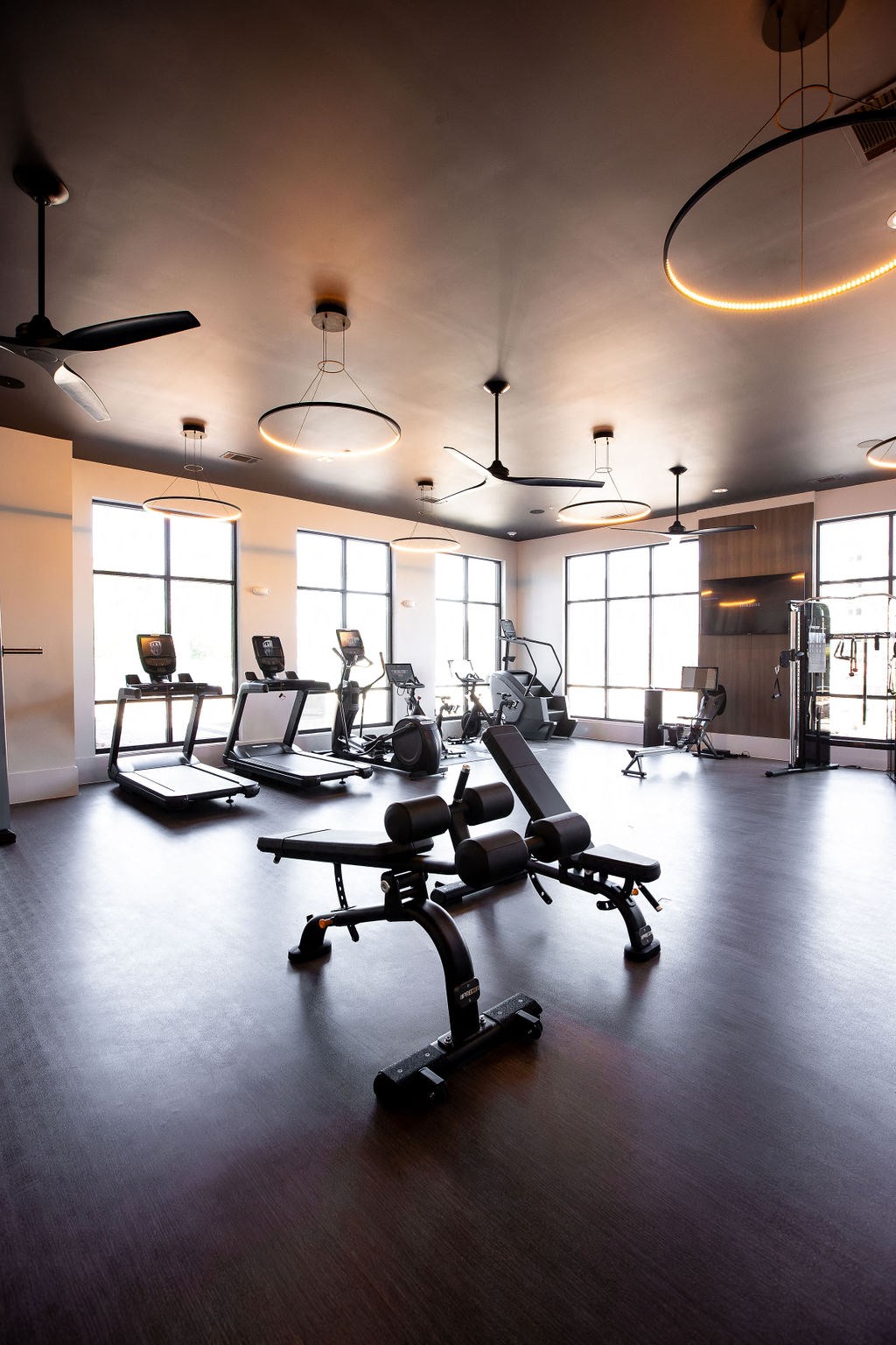 a fitness room with weights and chairs in it
