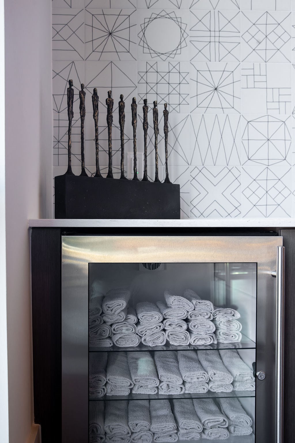 a rack of folded towels in a refrigerator