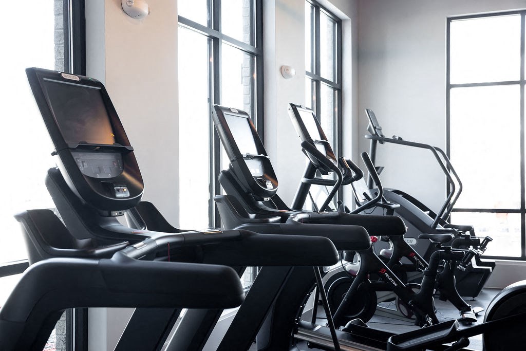 a row of exercise bikes in a gym