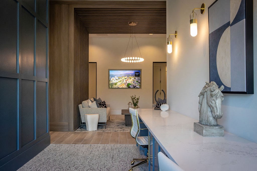 a kitchen with a marble counter top and a living room with a tv