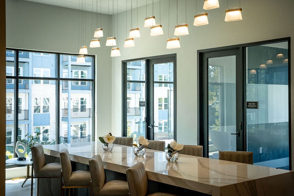a large communal table in a conference room with large windows