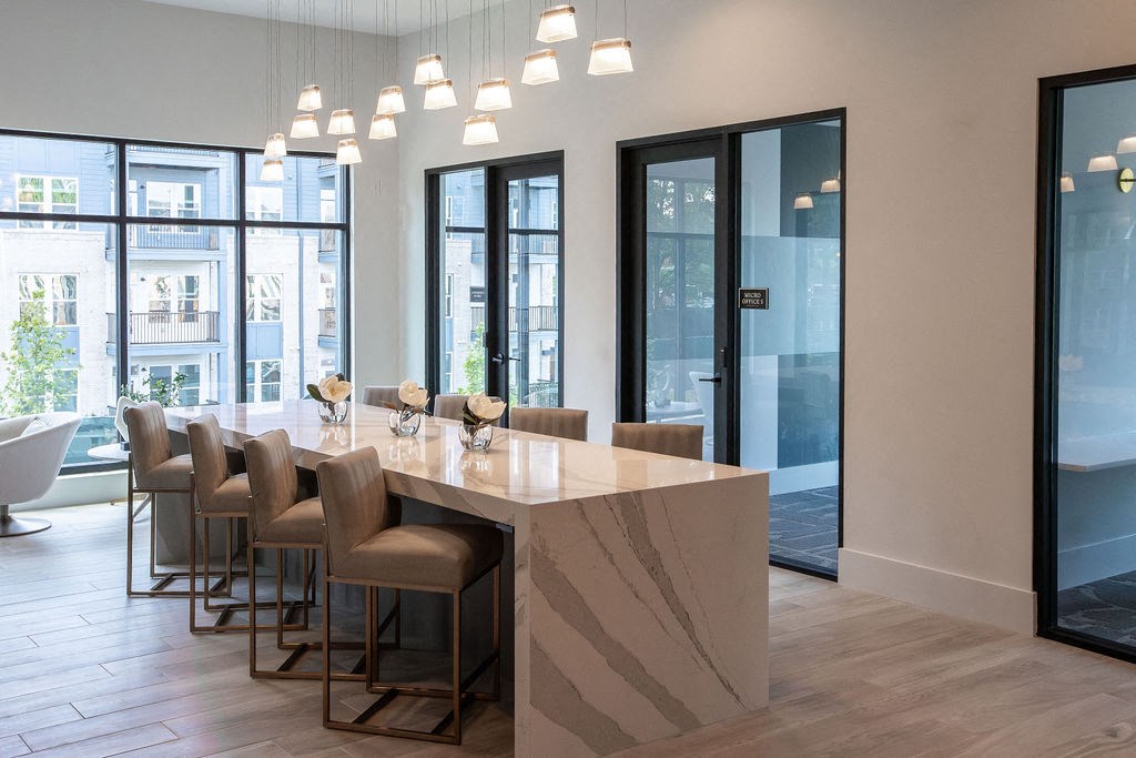 a dining room with a marble table and chairs in a lobby