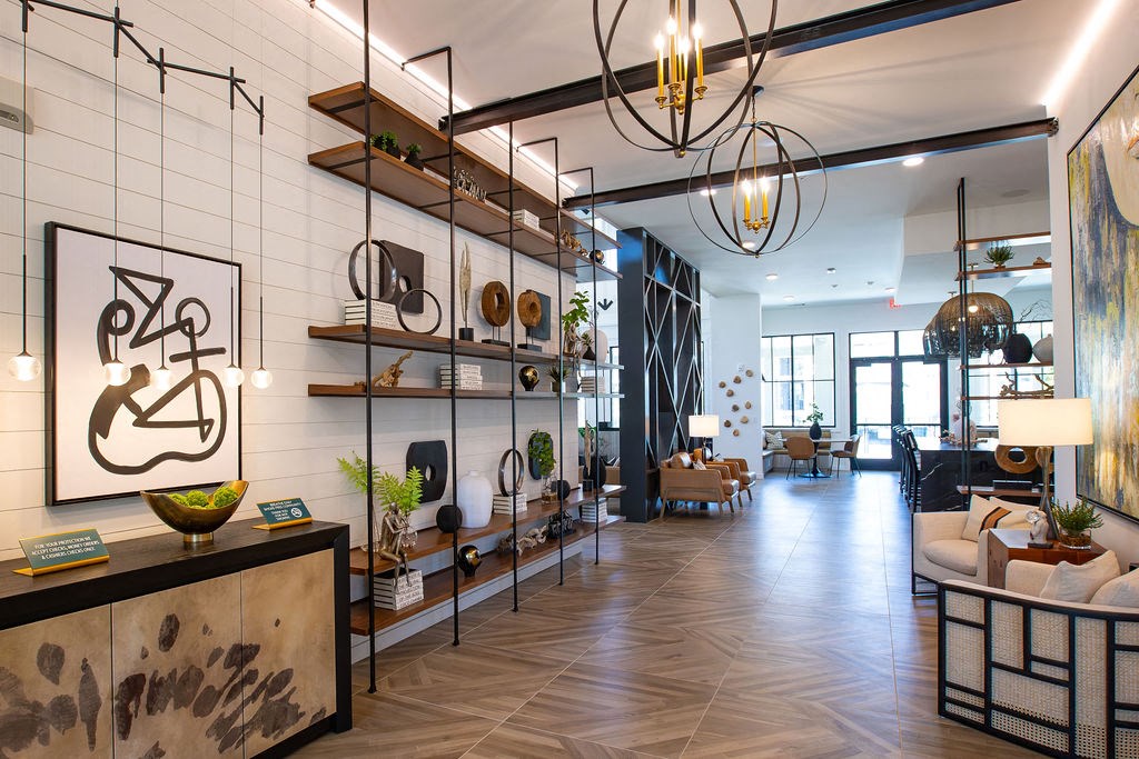 a living room with a white brick wall and a lobby with furniture