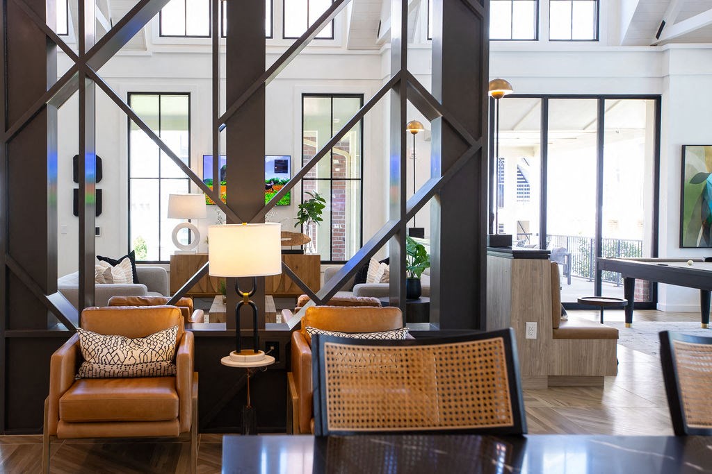 the lobby of a hotel with chairs and a table