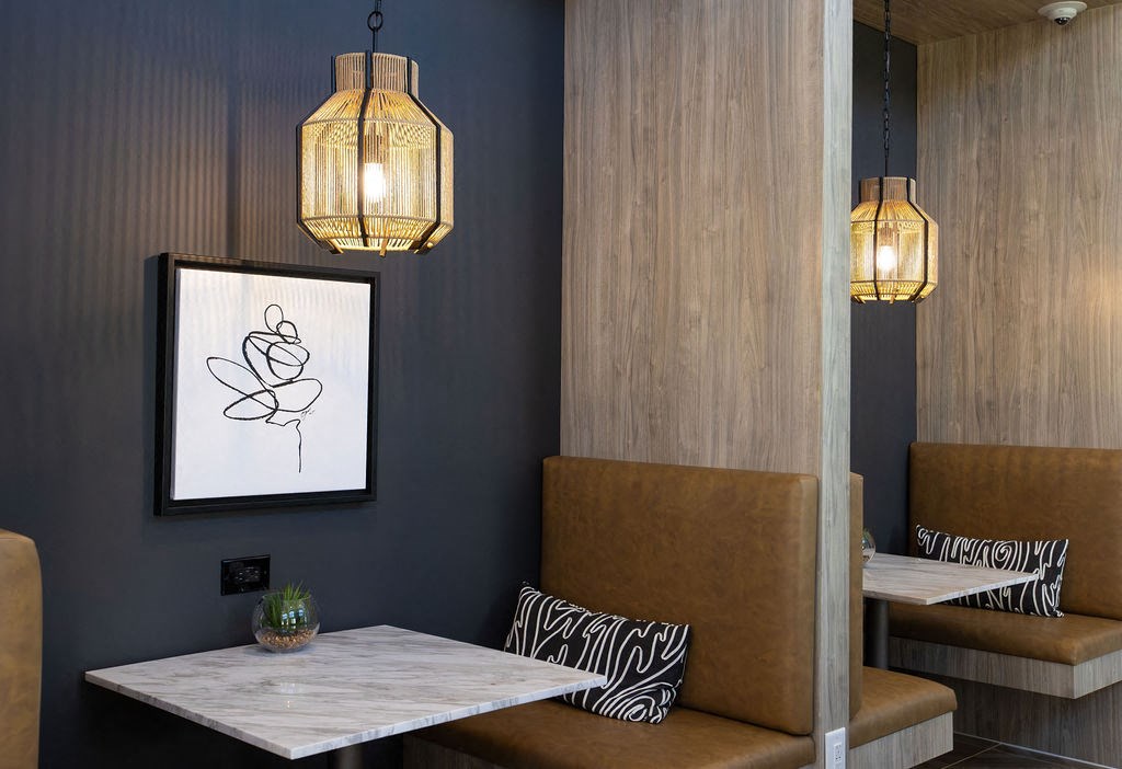 a dining room with a table and chairs and a picture on the wall