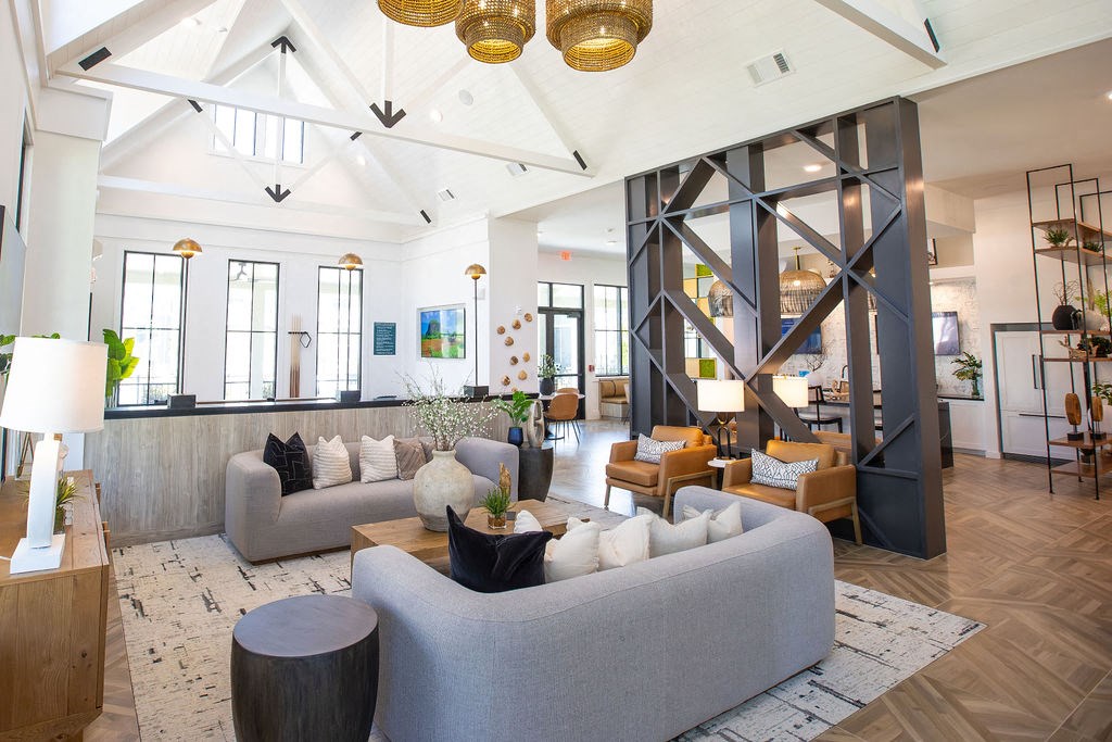 a living room with couches and chairs and a large window