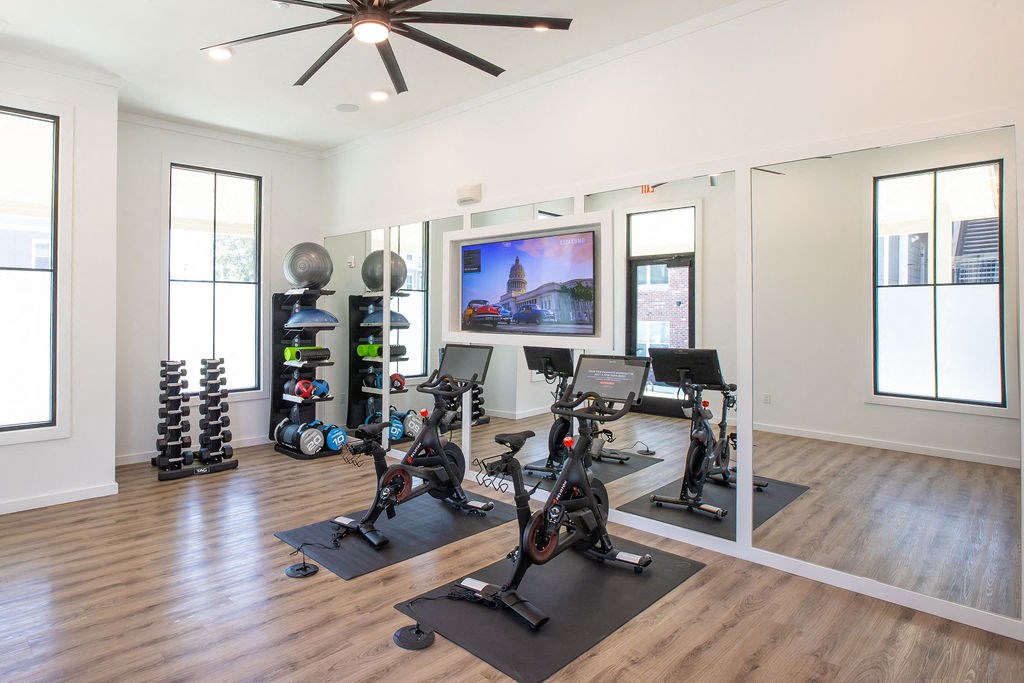 a home gym with weights and a tv on the wall
