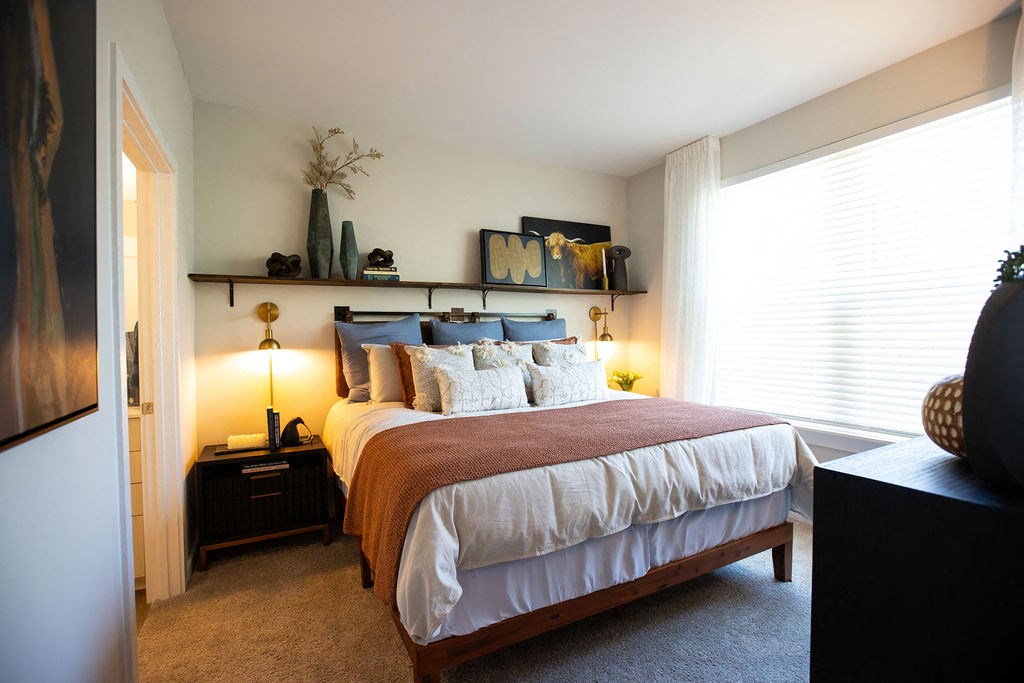 a bedroom with a bed and a window