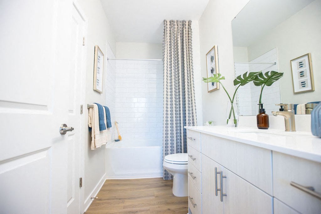 a white bathroom with a shower and a toilet
