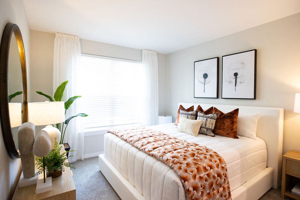 a bedroom with a bed and a window