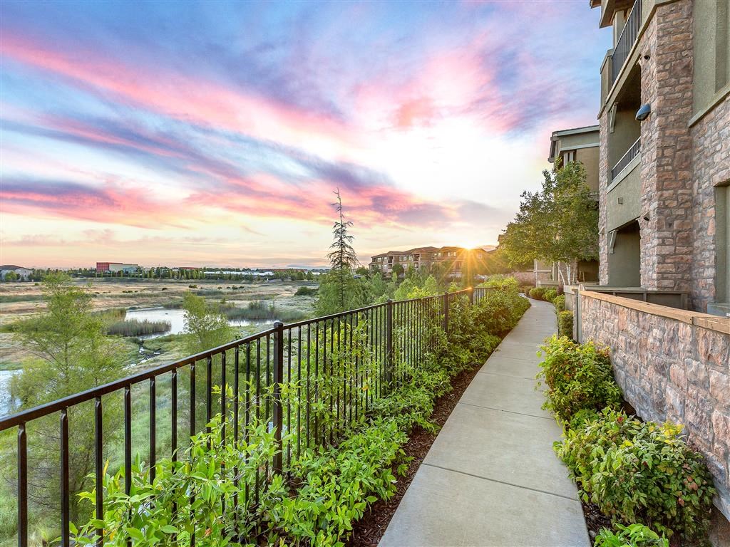 sunset and blue skyline along apartment exteriors