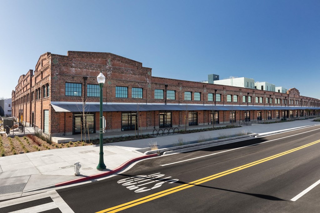 a large brick building with a street in front of it