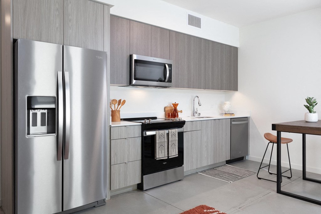 a kitchen with stainless steel appliances and a refrigerator