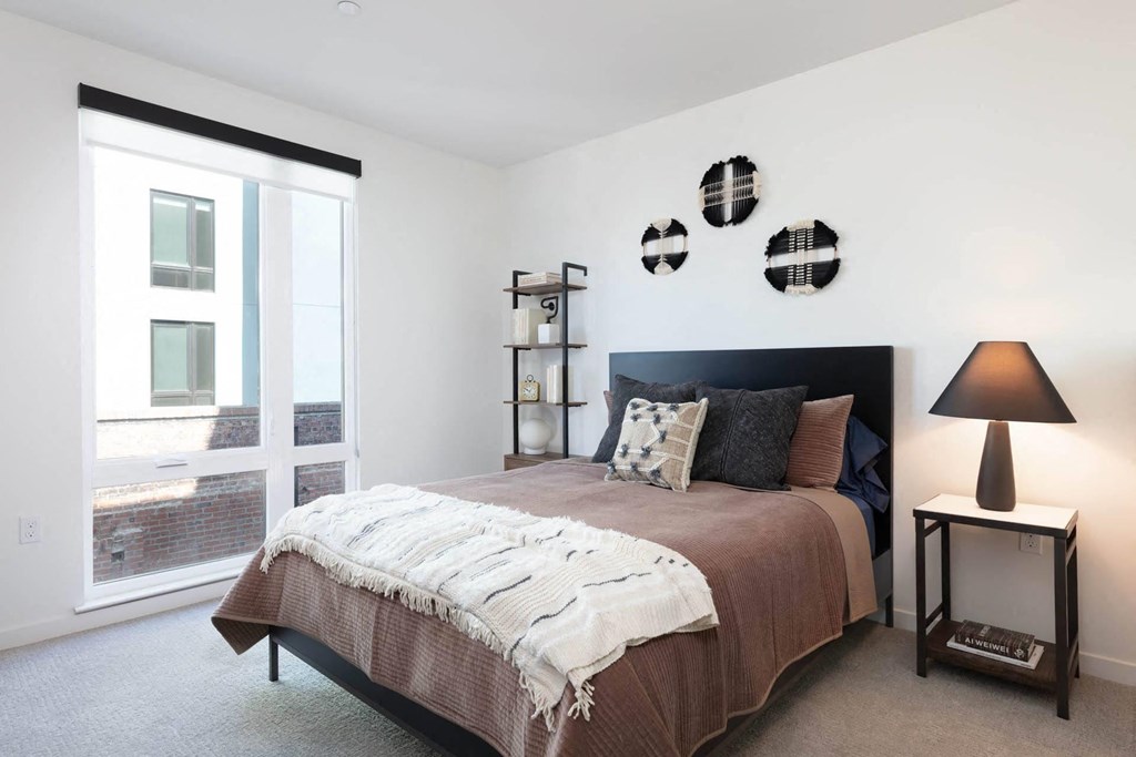 a bedroom with a bed and a window