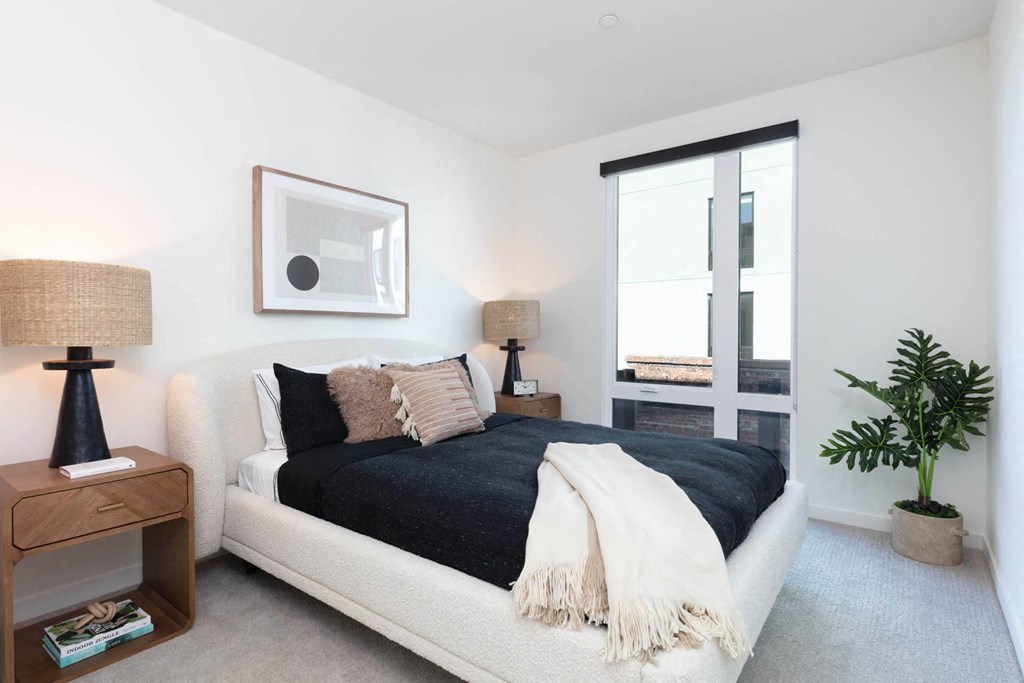 a bedroom with a bed and a window