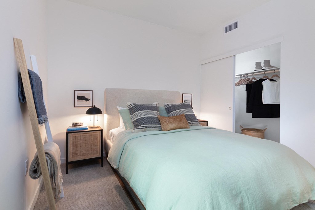 a bedroom with a large bed and a closet