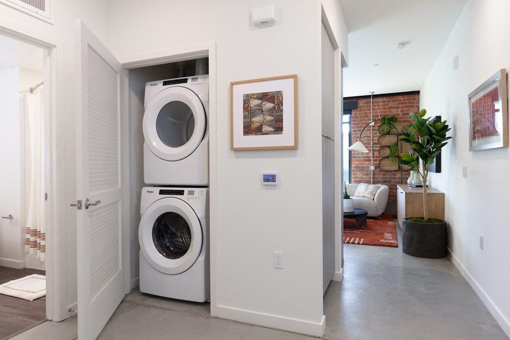 a white laundry room with a washing machine and a dryer