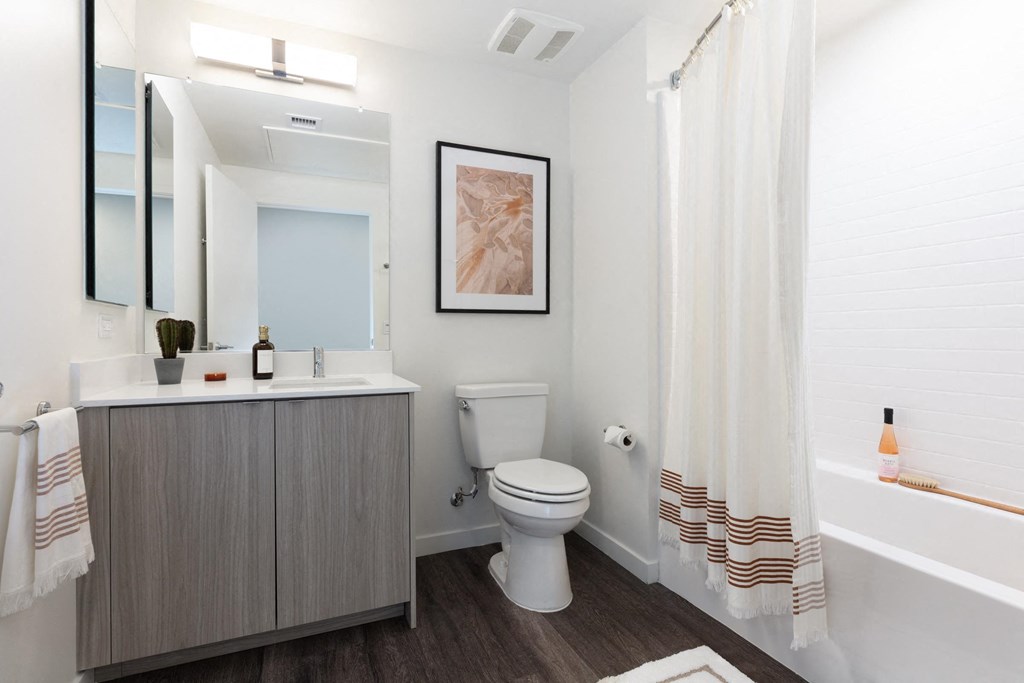 a bathroom with a toilet and a sink and a shower