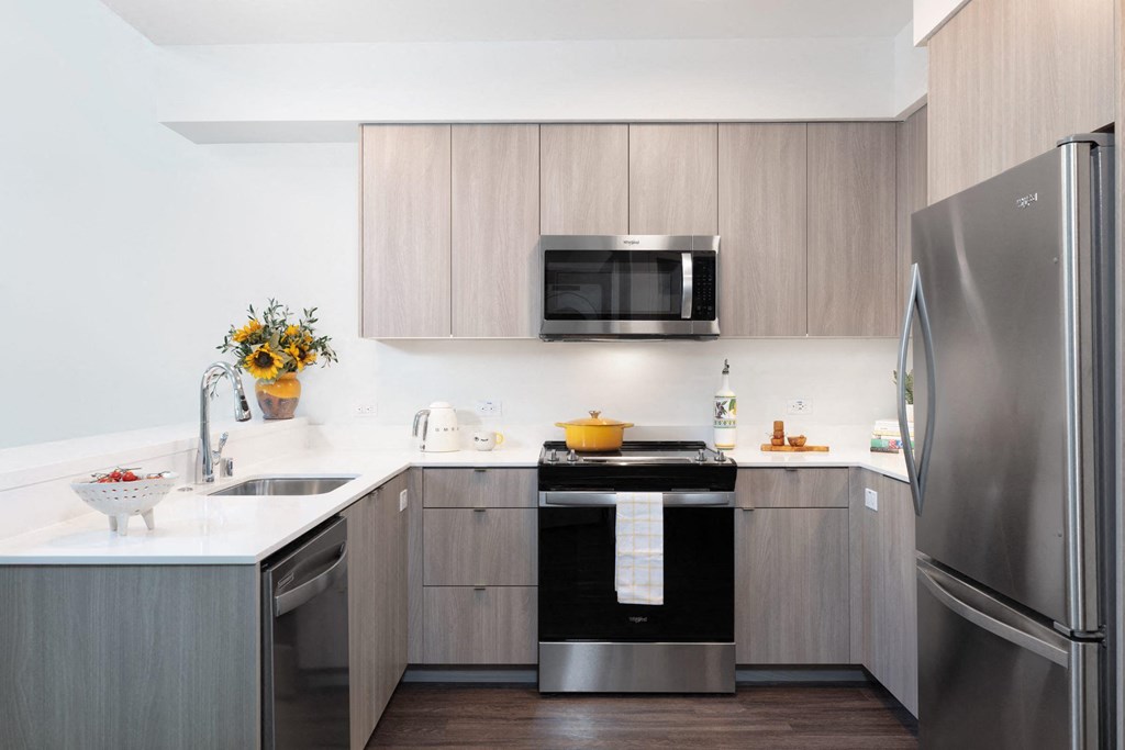 a kitchen with stainless steel appliances and wooden cabinets