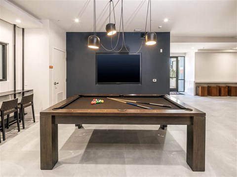 a pool table and a tv in a living room