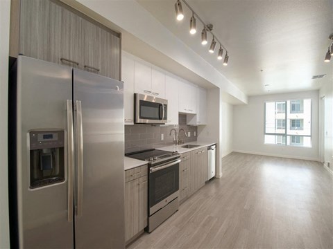 a kitchen with a stainless steel refrigerator and a stove