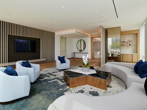 a large living room with white furniture and a television