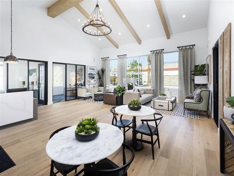 a living room with a table and chairs and a large window