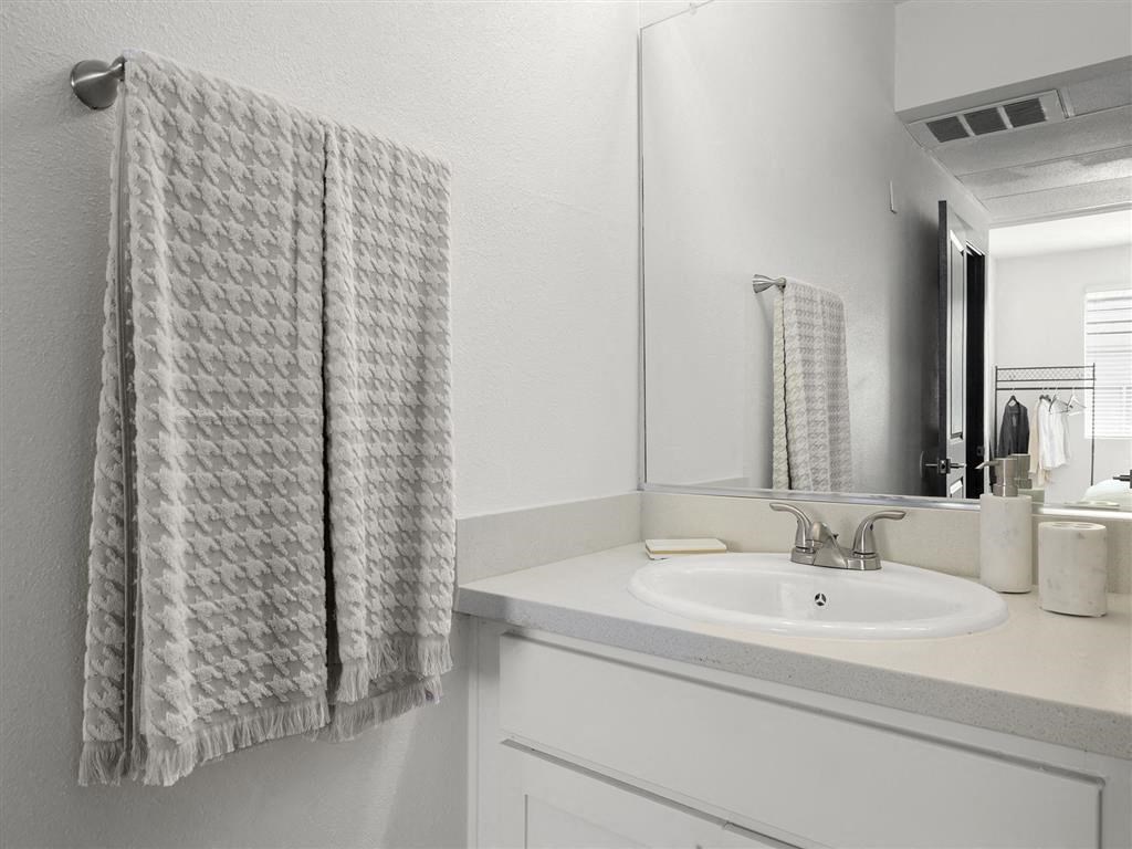 a bathroom with a sink and a mirror at Enclave, Paramount California